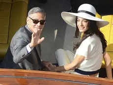 George Clooney and his wife Amal Alamuddin leave the city hall after their civil marriage ceremony in Venice, Italy, Monday, Sept. 29, 2014. George Clooney married human rights lawyer Amal Alamuddin Saturday, the actor's representative said, out of sight of pursuing paparazzi and adoring crowds. (AP Photo/Luigi Costantini)