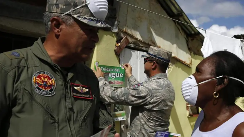 epa05135587 Members of Dominican Army provide information to residents to help prevent the propagation of "Aedes Aegypti" mosquito, transmitter of Zika, dengue fever and other diseases, in Guerra, Dominican Republic, 30 January 2016. The fast spread of the Zika virus in the Americas has prompted the World Health Organization to discuss whether the outbreak constitutes a global health emergency. WHO officials said there may have been 1.5 million Zika cases in Brazil, where the outbreak started last year, and that the number of cases in the Americas could grow to 4 million within 12 months. EPA/Orlando Barria