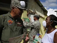 epa05135587 Members of Dominican Army provide information to residents to help prevent the propagation of "Aedes Aegypti" mosquito, transmitter of Zika, dengue fever and other diseases, in Guerra, Dominican Republic, 30 January 2016. The fast spread of the Zika virus in the Americas has prompted the World Health Organization to discuss whether the outbreak constitutes a global health emergency. WHO officials said there may have been 1.5 million Zika cases in Brazil, where the outbreak started last year, and that the number of cases in the Americas could grow to 4 million within 12 months. EPA/Orlando Barria