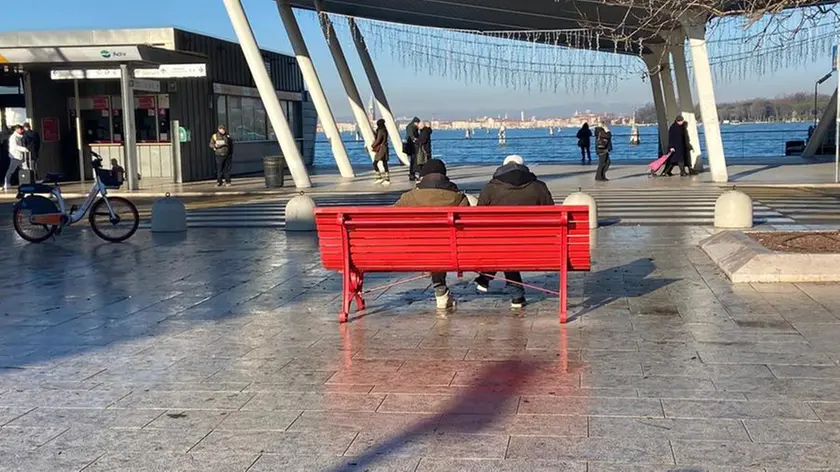Due senzatetto sulla panchina rossa del Lido