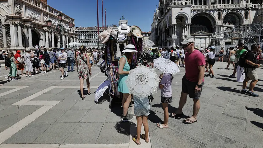 Turisti alle bancarelle degli ambulanti di Piazza San Marco