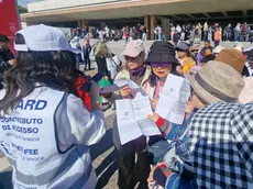 Alcuni turisti pendolari mentre mostrano la ricevuta di pagamento del contributo di accesso