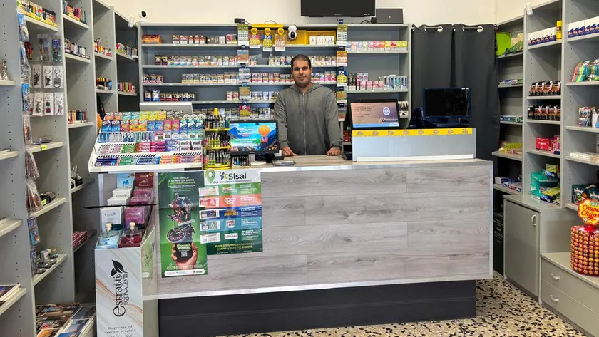 Giacomo Habli dietro al bancone della tabaccheria