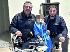 I due agenti di P olizia con il bimbo e la bicicletta ritrovata