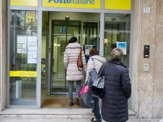 Persone in coda allo sportello bancomat