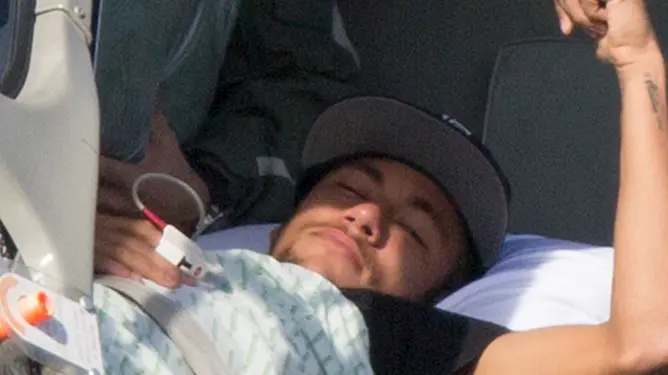 Brazil's Neymar lies inside a medical helicopter at the Granja Comary training center, in Teresopolis, Brazil, Saturday, July 5, 2014. Neymar was airlifted from Brazil's training camp Saturday and will be treated at home for his back injury. Neymar, the biggest football star in Brazil, was ruled out of the rest of the World Cup after fracturing his third vertebra during Friday's 2-1 quarterfinal win over Colombia. (AP Photo/Leo Correa)