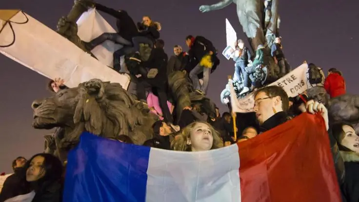 epa04555939 People gather on the monument on Place de la Nation as millions of people march against terrorism in Paris, France, 11 January 2015. Hundreds of thousands of people and more than 40 world leaders were expected for the march honouring the 17 victims killed in three days of terror earlier in the week, which started when gunmen invaded French satirical magazine Charlie Hebdo, continued with the shooting of a policewoman and ended with the siege of a Jewish supermarket EPA/IAN LANGSDON