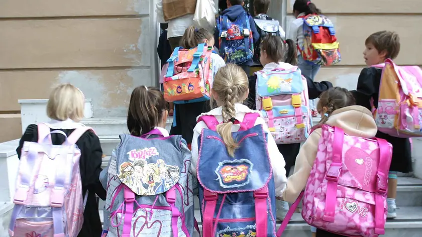 GENOVA 20030915 20030915 - GENOVA - CRO - SCUOLA: VACANZE FINITE - Un gruppo di scolari entra a scuola per il primo giorno di lezione, oggi a Genova. Torna a suonare la campanella per gli studenti italiani, il rientro in classe riguardera', tranne poche eccezioni, l'intera categoria. LUCA ZENNARO/ANSA/TO (LUCA ZENNARO/ ) Primo giorno di scuola in una scuola elementare Alunni delle elementari. Per loro novita' in vista Alunni delle elementari al rientro a scuola