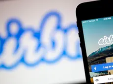 The Airbnb Inc. application and logo are displayed on an Apple Inc. iPhone and iPad in this arranged photograph in Washington, D.C., U.S., on Friday, March 21, 2014. Airbnb Inc. is raising money from investors including TPG Capital in a financing round that would value the room-sharing service at more than $10 billion, said people with knowledge of the deal. Photographer: Andrew Harrer/Bloomberg via Getty Images