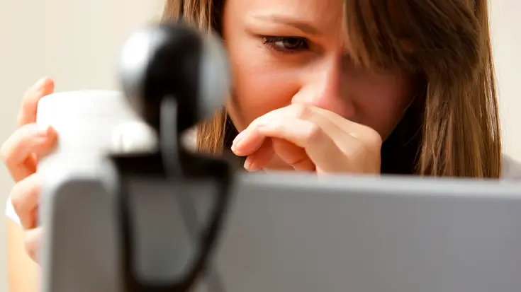 UK --- Close up of a woman using laptop computer with web cam --- Image by © Julian Winslow/ableimages/Corbis