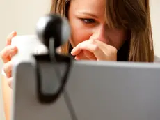 UK --- Close up of a woman using laptop computer with web cam --- Image by © Julian Winslow/ableimages/Corbis