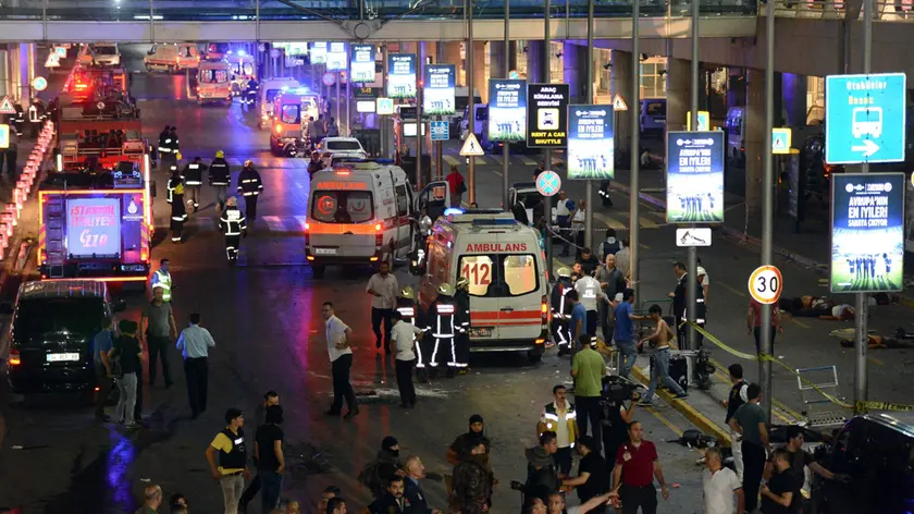 Turkish rescue services gather outside Istanbul's Ataturk airport, Tuesday, June 28, 2016. Two explosions have rocked Istanbul's Ataturk airport, killing several people and wounding others, Turkey's justice minister and another official said Tuesday. A Turkish official says two attackers have blown themselves up at the airport after police fired at them. The official said the attackers detonated the explosives at the entrance of the international terminal before entering the x-ray security check. (Ismail Coskun, IHA via AP) TURKEY OUT