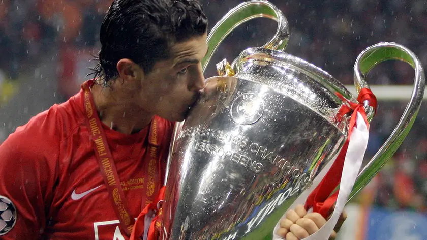 FILE -nIn this May 21, 2008 file photo, Manchester United's Cristiano Ronaldo kisses the trophy at the end of the Champions League final soccer match at the Luzhniki Stadium in Moscow. Cristiano Ronaldo is headed back to Manchester United. The English club says it has reached an agreement with Juventus for the transfer of the Portugal forward subject to agreement of personal terms, visa and medical examination. (AP Photo/Sergey Ponomarev, File)