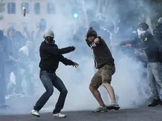 Supporters face policemen outside Olimpico Stadium at the end of Italian Serie A soccer match between As Roma and Ss Lazio, Rome 25 May 2015. Two soccer fans were stabbed near the Olympic stadium before the highly anticipated Roma-Lazio derby, police said Monday. The pair, each stabbed in the abdomen, were rushed by ambulance to hospital as code red emergencies.ANSA/ANGELO CARCONI