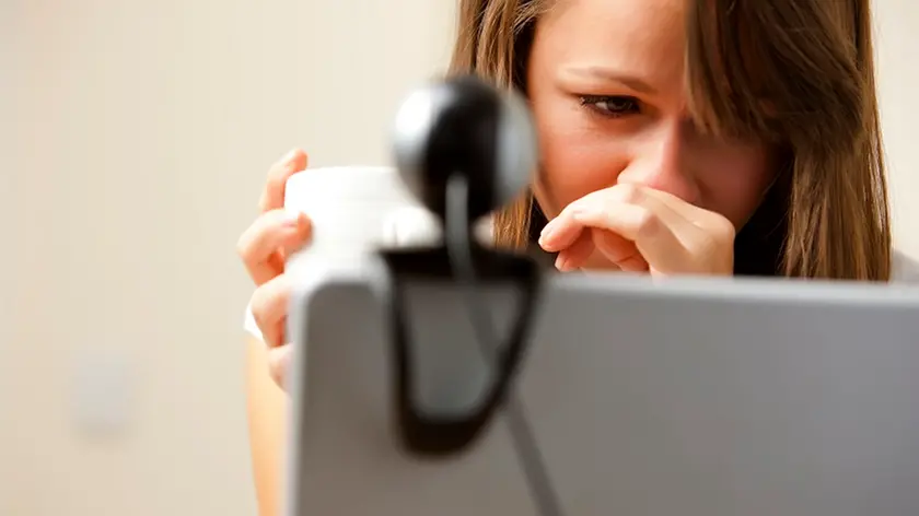 UK --- Close up of a woman using laptop computer with web cam --- Image by © Julian Winslow/ableimages/Corbis