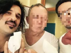 Mauro Marin, con due compagni di stanza in ospedale, mostra la mano operata