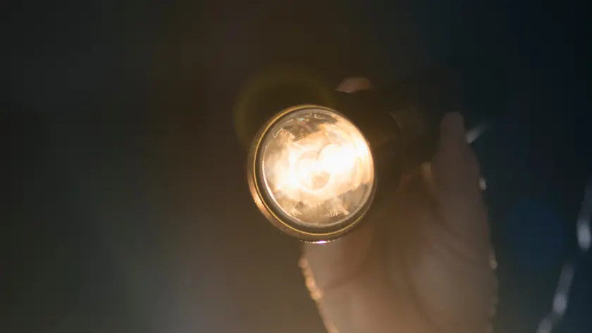 Hand holding flashlight