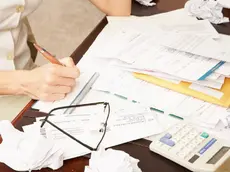 Frustrated Woman Paying Bills and Working on Home Finances --- Image by © Jack Hollingsworth/Corbis