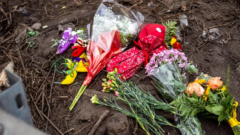 Flowers in the place where a bus with people on board fell from an elevated section ending up on the railway track that runs alongside the road, in Mestre,near Venice