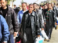 Syrian citizens leave the Moadamiyeh suburb, Damascus, Syria, 29 October 2013. Officials at the Syrian Red Crescent said that 3500 civilians have been evacuated since the beginning of October from Moadamiyeh, which has been under siege by Syrian government troops for months. Moadamiyeh had suffered shortages of medical and food supplies. ANSA/STR