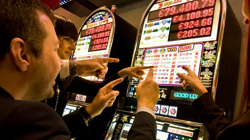 Italy, Val D'Aosta, Saint Vincent, people at slot machine