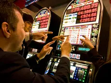 Italy, Val D'Aosta, Saint Vincent, people at slot machine