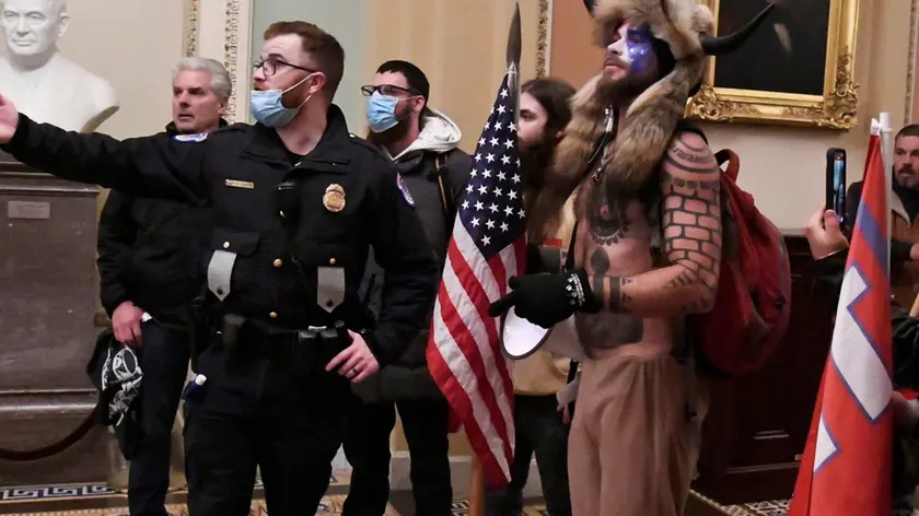 Police speak to supporters of U.S. President Donald Trump as they demonstrate on the second floor of the U.S. Capitol near the entrance to the Senate after breaching security defenses, in Washington, U.S., January 6, 2021. Picture taken January 6, 2021. REUTERS/Mike Theiler TPX IMAGES OF THE DAY