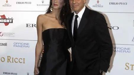 George Clooney and his fiancee Amal Alamuddin pose for photographers as they arrive for the "Celebrity Fight Night" foundation gala dinner, in Florence, Italy, Sunday, Sept. 7, 2014. (AP Photo/Francesco Bellini)