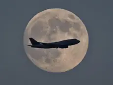 epa03755954 A Jumbo jet is silhoutted against the moon on it's landing flight path to Frankfurt am Main airport, Frankfurt am Main, Germany, 22 June 2013. Reports state on 23 June 2013 the moon will be at its closest point to Earth, called perigee. This relatively close brush will happen as the moon enters its fullest phase, creating the cosmic coincidence known as the supermoon. At its fullest and closest, the moon will appear about 12 per cent larger in the sky. EPA/FRANK RUMumpenhorst